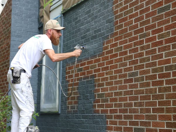 spray painting exterior brick house